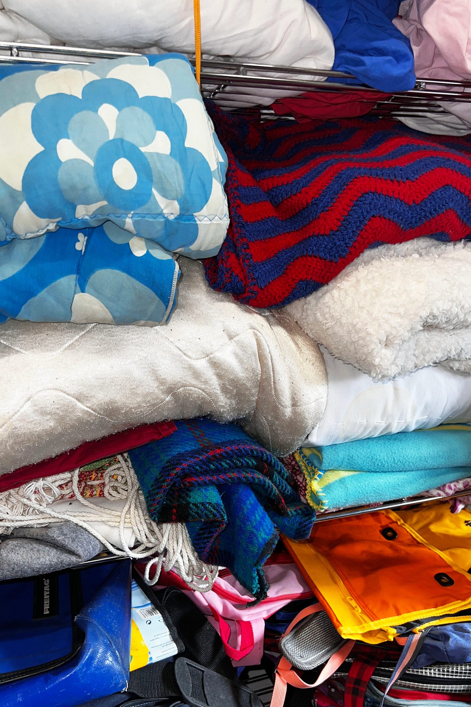 Stacks of blankets, cushions and textiles