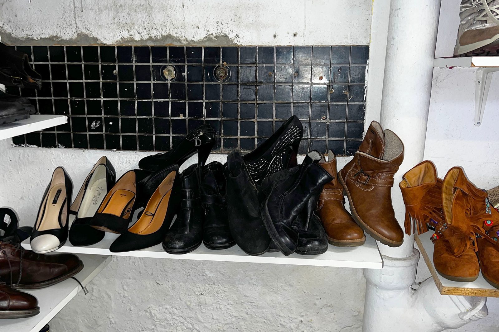 A shelf of second-hand shoes and boots